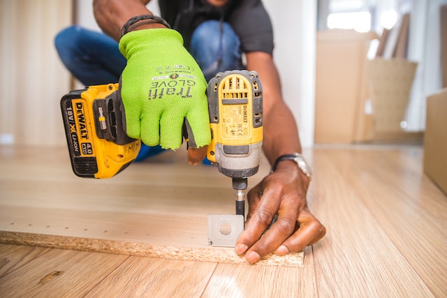 worker-intalling-floors-with-drill